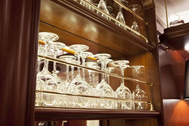 a glass case with a variety of glass items on it aboard KAMAXITHA Yacht for Sale