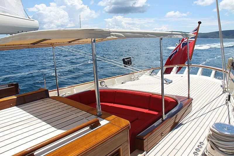 a boat with a flag on the front aboard KAMAXITHA Yacht for Sale