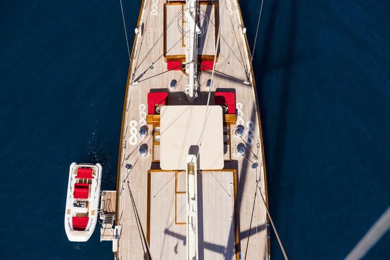 a large white boat with red and black stripes on it aboard KAMAXITHA Yacht for Sale