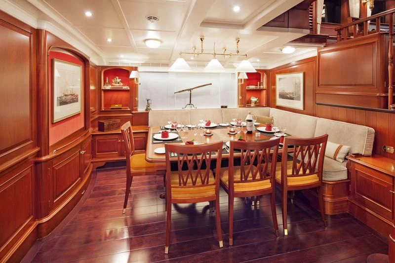 a dining room with a table and chairs aboard KAMAXITHA Yacht for Sale