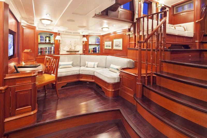 a living room with a staircase aboard KAMAXITHA Yacht for Sale