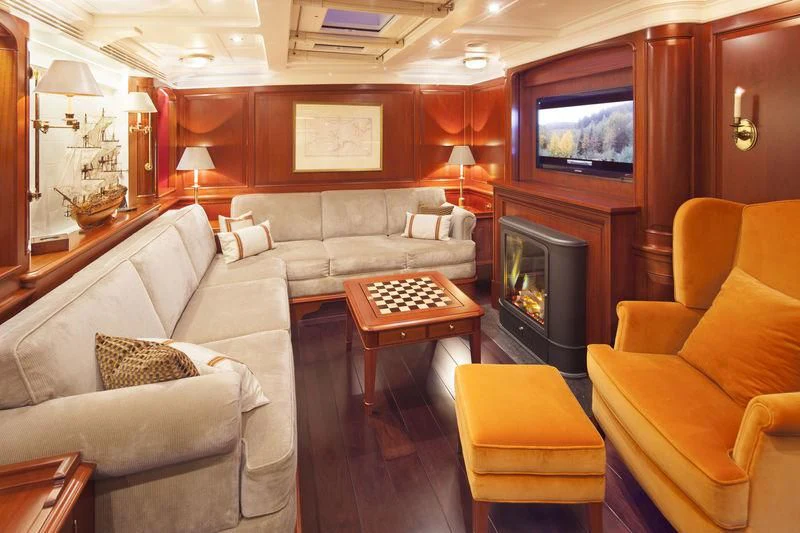 a living room with a couch and a tv aboard KAMAXITHA Yacht for Sale