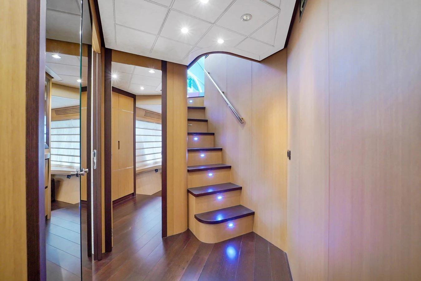 a room with a wood floor and a staircase aboard JERICO V Yacht for Sale