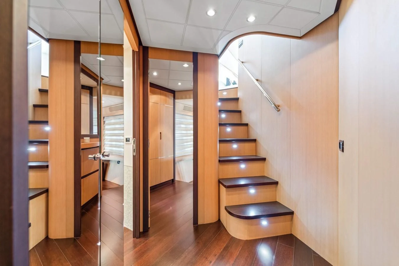 a room with wooden cabinets and a staircase aboard JERICO V Yacht for Sale