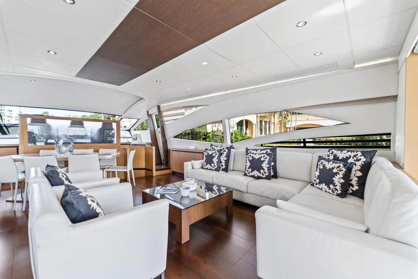 a living room with white couches aboard JERICO V Yacht for Sale