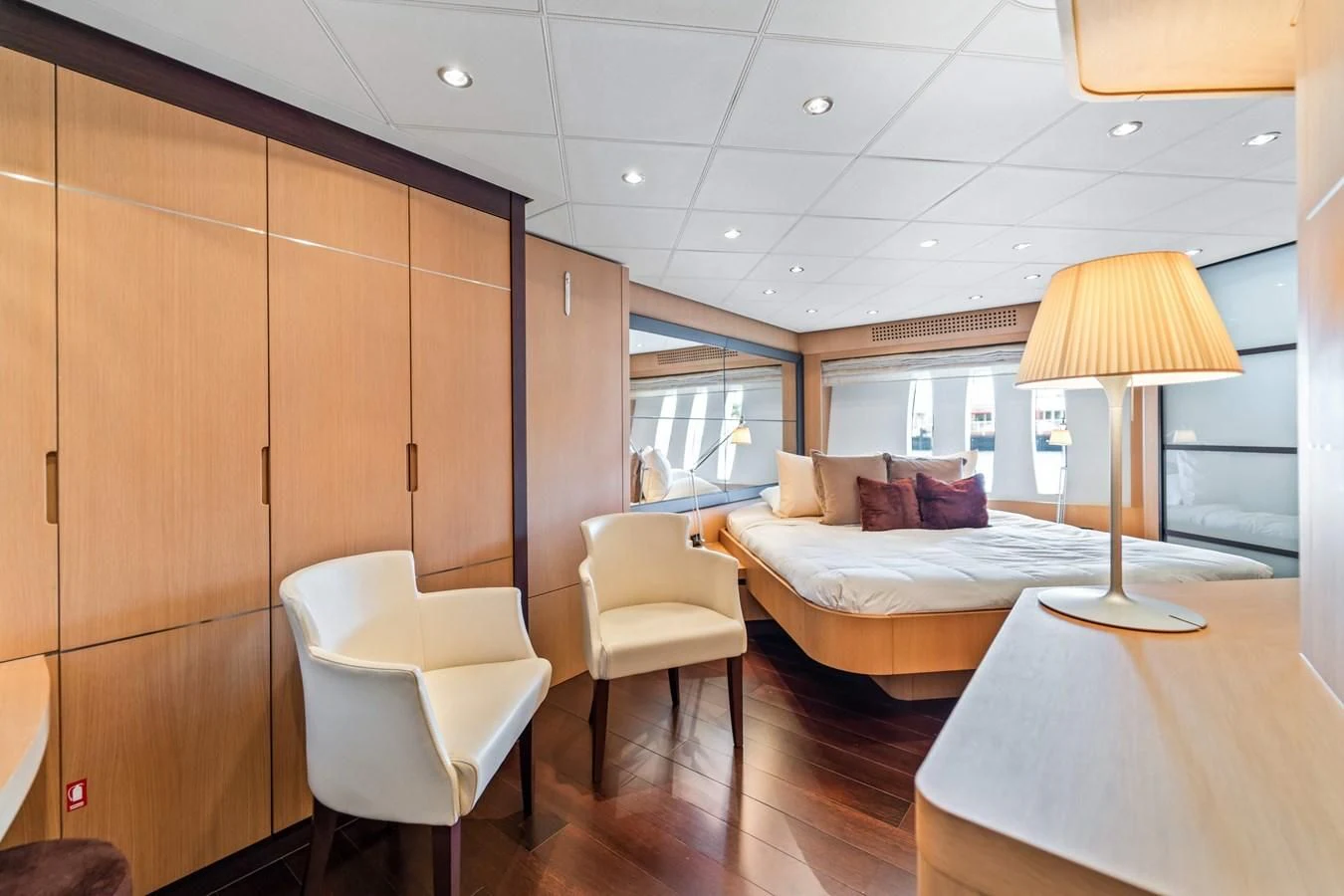 a bedroom with a bed and a table aboard JERICO V Yacht for Sale