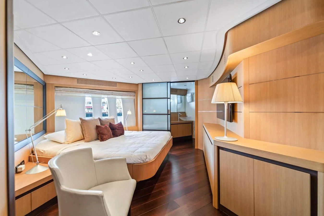 a room with a bed and a chair aboard JERICO V Yacht for Sale