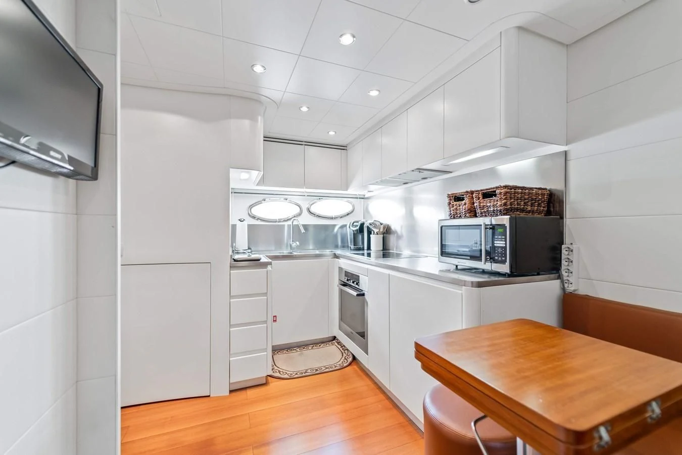 a kitchen with white cabinets aboard JERICO V Yacht for Sale