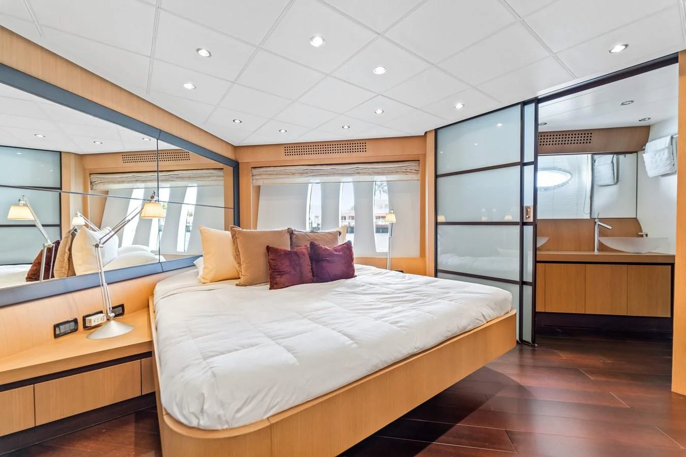 a bedroom with a large mirror aboard JERICO V Yacht for Sale