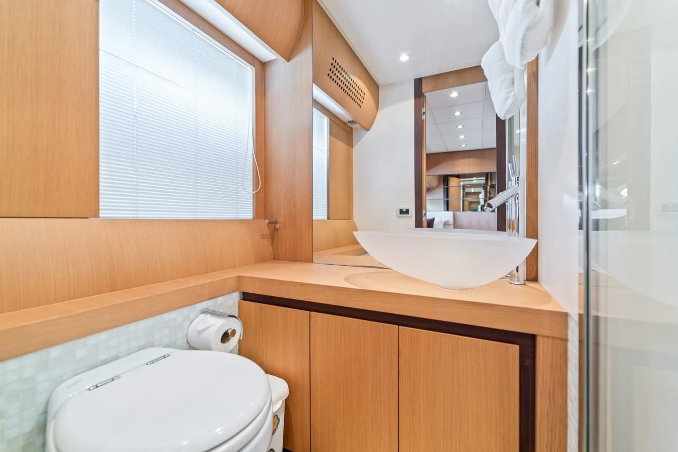 a bathroom with a toilet and a sink aboard JERICO V Yacht for Sale