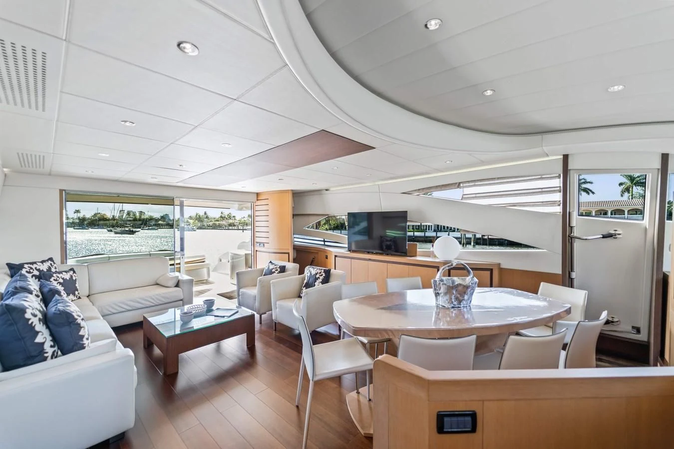 a living room with a table and chairs aboard JERICO V Yacht for Sale