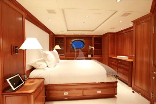 a bedroom with a bed and a desk aboard PERSEUS Yacht for Sale