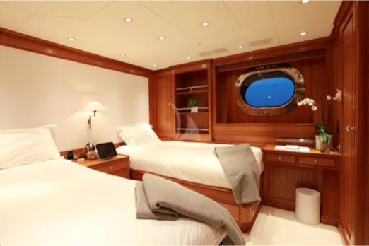 a room with a bed and a television aboard PERSEUS Yacht for Sale