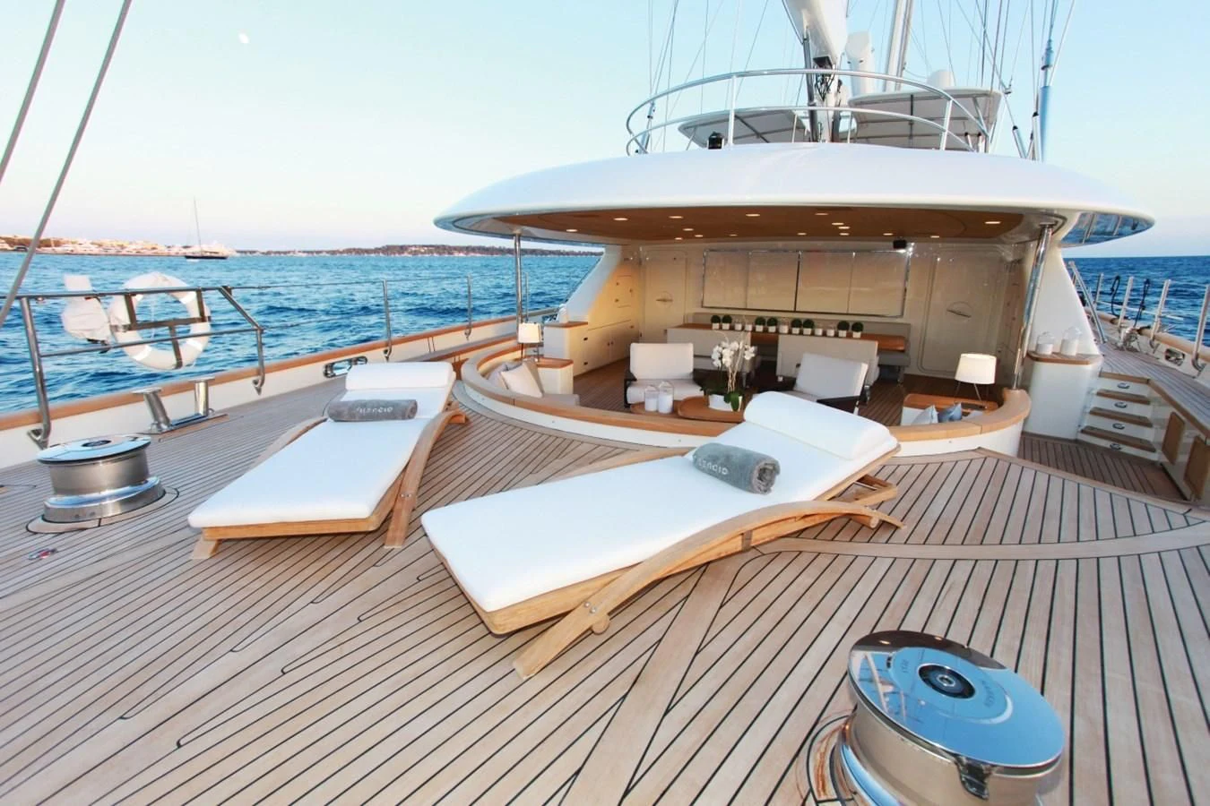 a deck with a large boat on it and a table on the side aboard PERSEUS Yacht for Sale