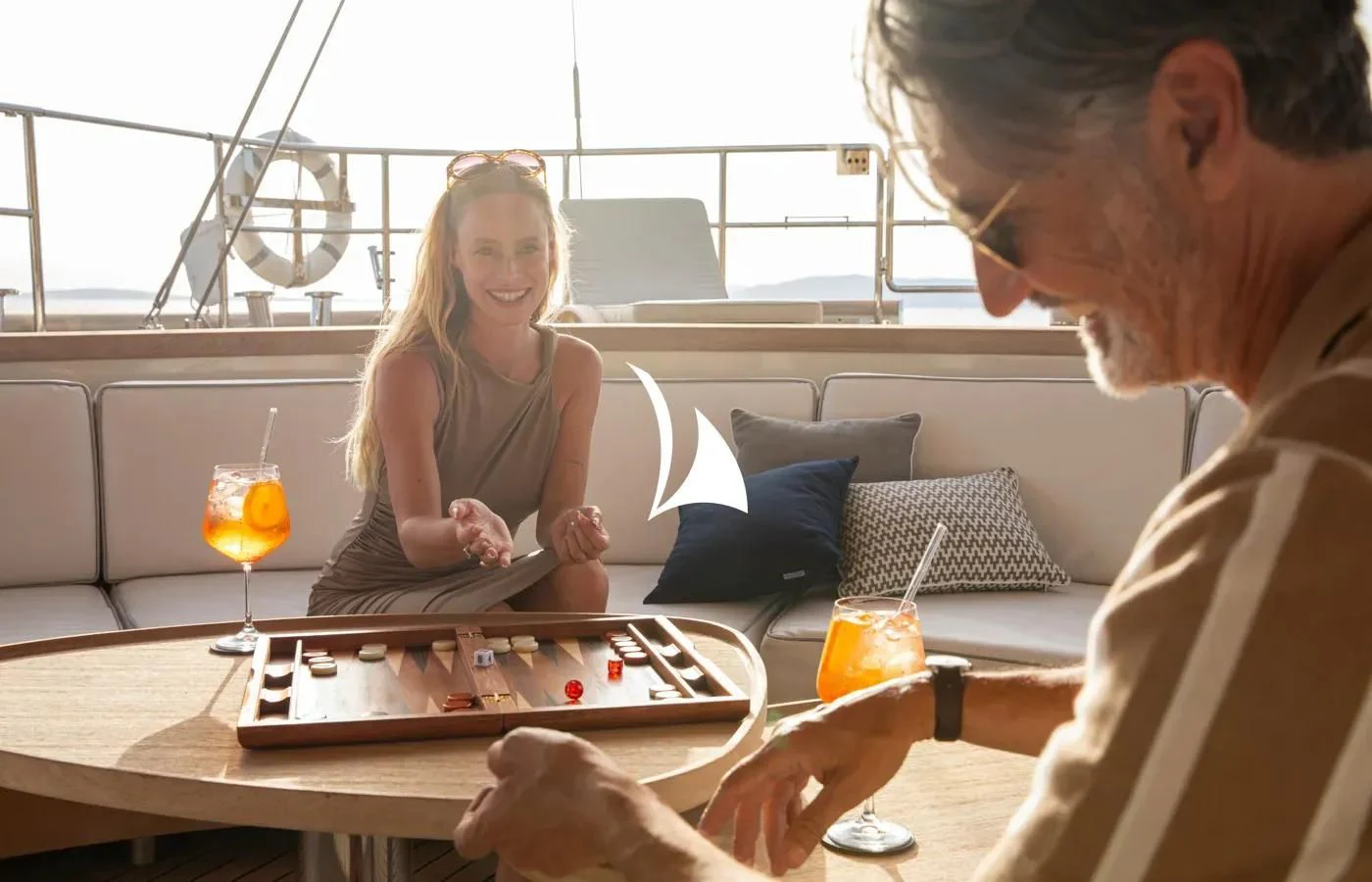 a man and a woman playing a board game aboard PERSEUS Yacht for Sale