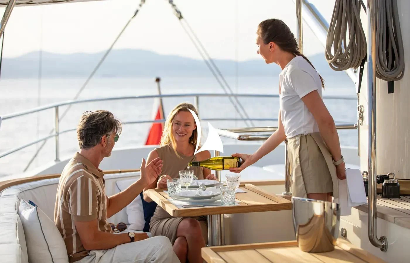 a man and a woman having a meal on a boat aboard PERSEUS Yacht for Sale