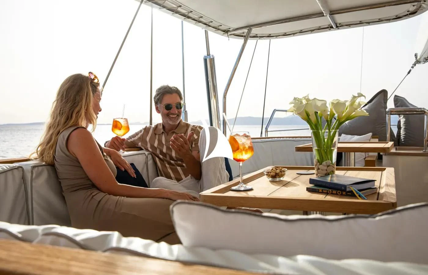 a man and a woman sitting on a boat with drinks aboard PERSEUS Yacht for Sale