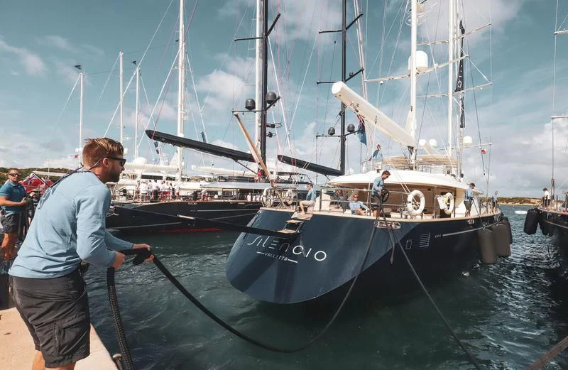 a man standing next to a boat aboard PERSEUS Yacht for Sale