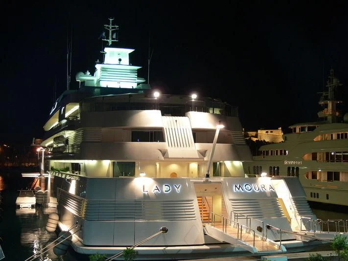 a ship docked at night aboard LADY MOURA Yacht for Sale