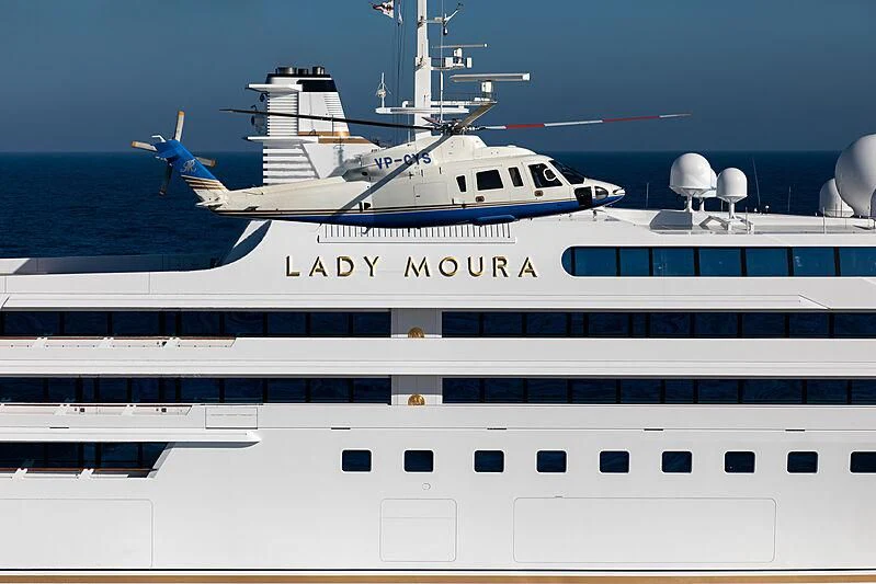 a white yacht with a helicopter on top of it aboard LADY MOURA Yacht for Sale