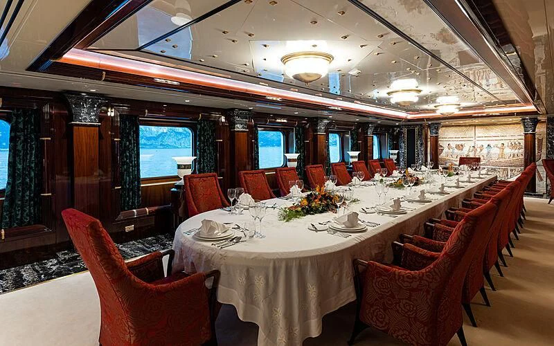a dining room with tables and chairs aboard LADY MOURA Yacht for Sale