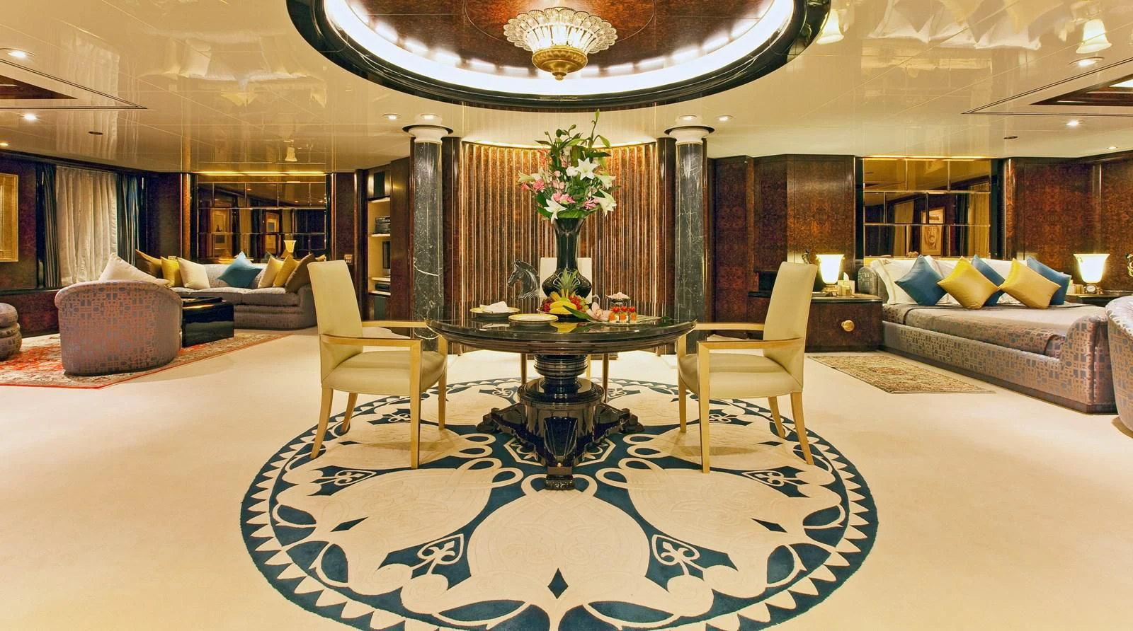 a large living room with a large blue and white rug aboard LADY MOURA Yacht for Sale