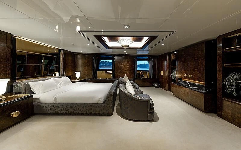 a large room with a bed and a chair aboard LADY MOURA Yacht for Sale