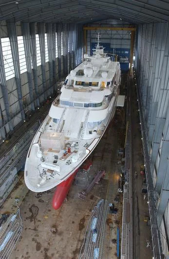 a large boat in a large warehouse aboard LADY MOURA Yacht for Sale