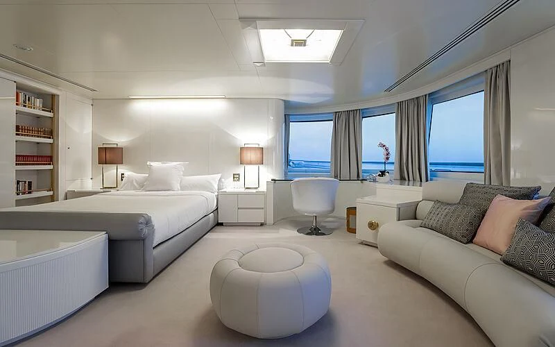a large white room with a large bed and a window aboard LADY MOURA Yacht for Sale
