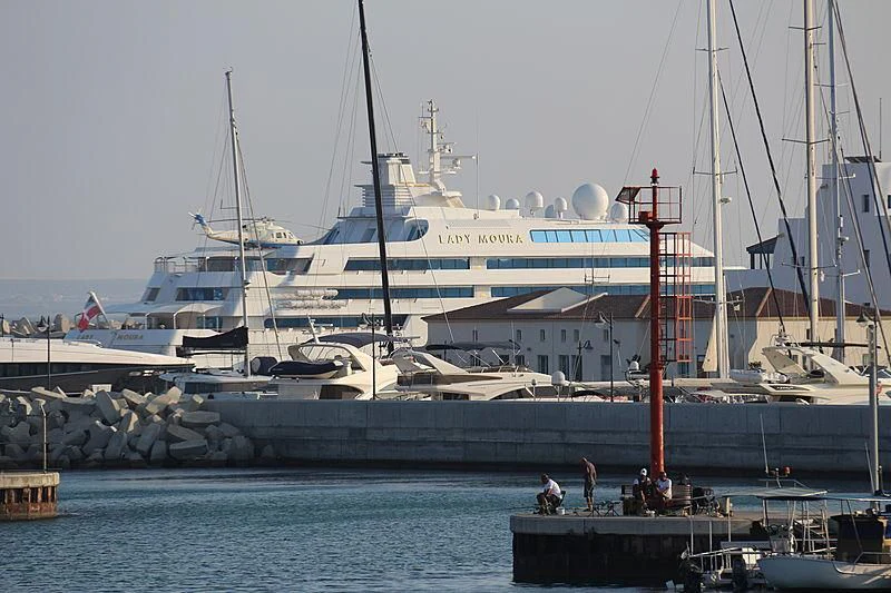 a large white boat with a red pole on the front aboard LADY MOURA Yacht for Sale