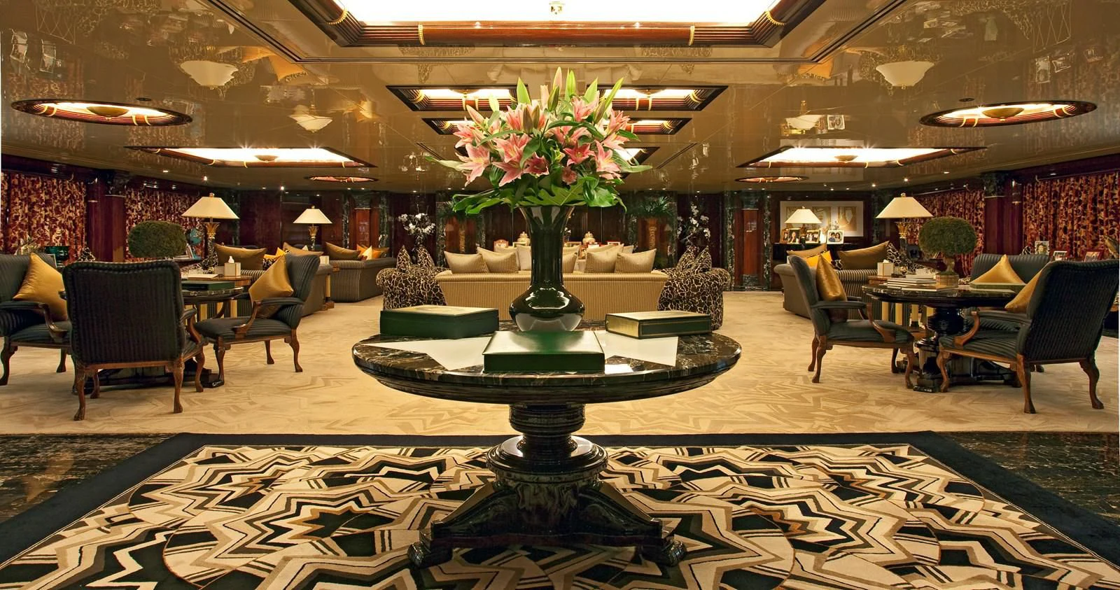 a room with a fountain and chairs aboard LADY MOURA Yacht for Sale
