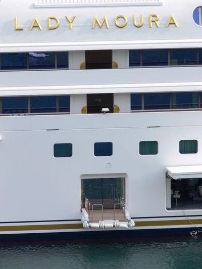 a white boat on a dock aboard LADY MOURA Yacht for Sale