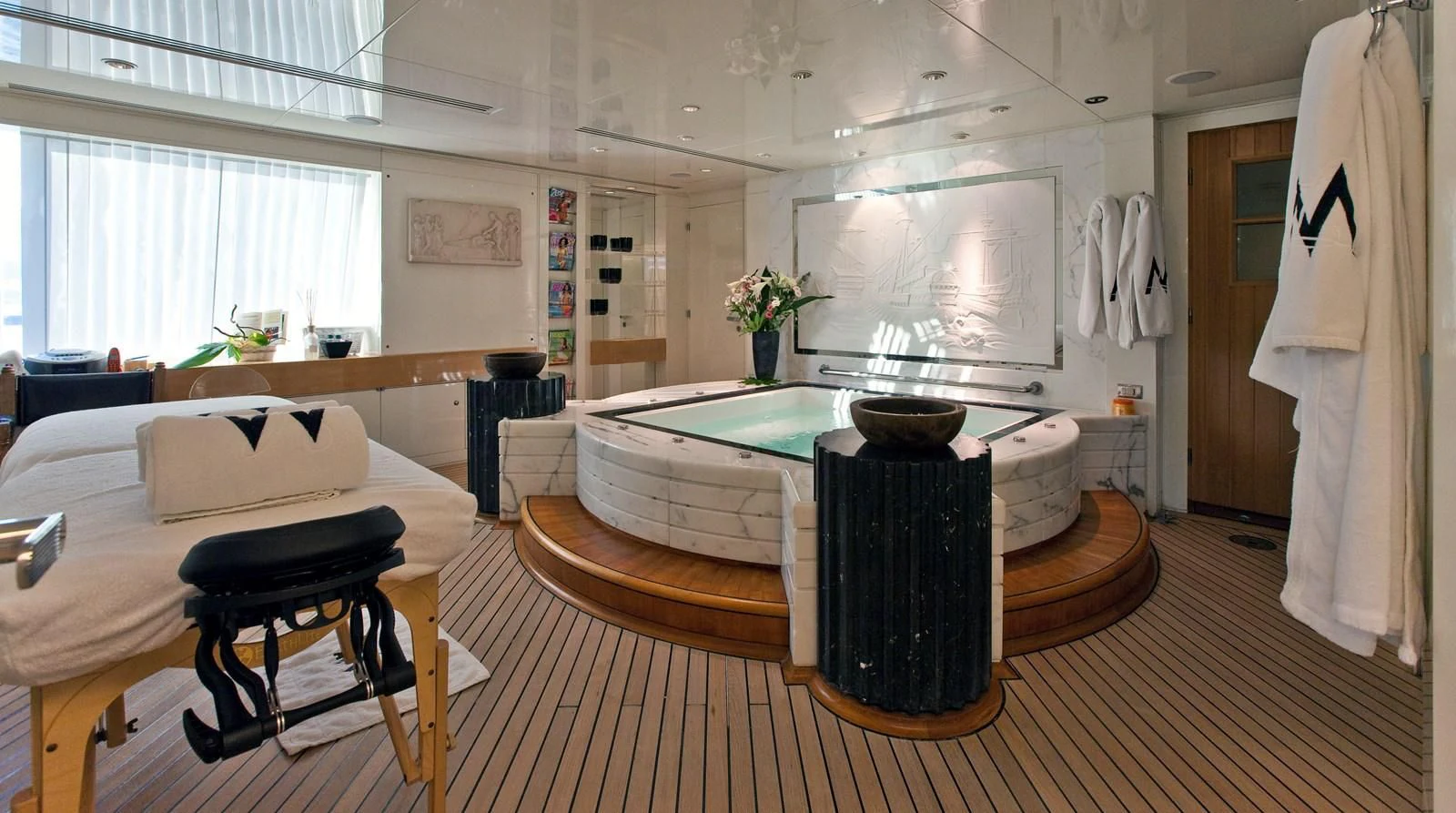 a room with a table and chairs aboard LADY MOURA Yacht for Sale