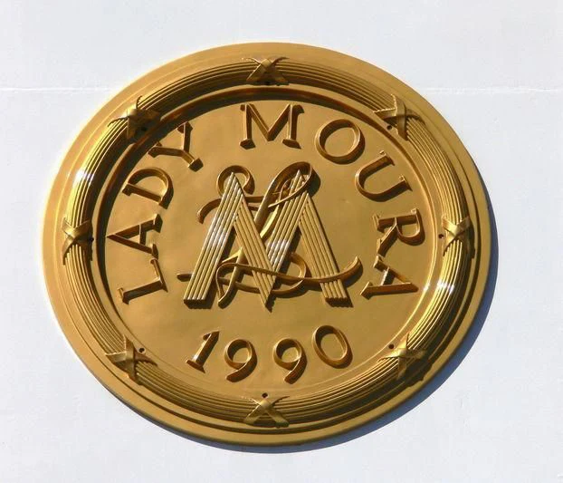 a gold coin with a symbol aboard LADY MOURA Yacht for Sale