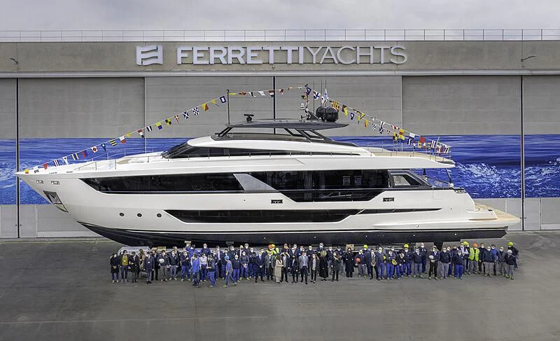 a group of people standing next to a large white boat aboard EPIC Yacht for Sale