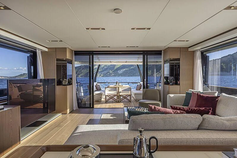 a living room with a large window aboard EPIC Yacht for Sale