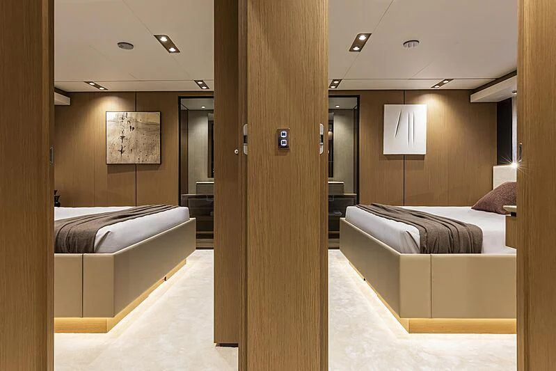 a room with a couple of beds aboard EPIC Yacht for Sale