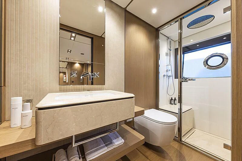 a bathroom with a tub and toilet aboard EPIC Yacht for Sale