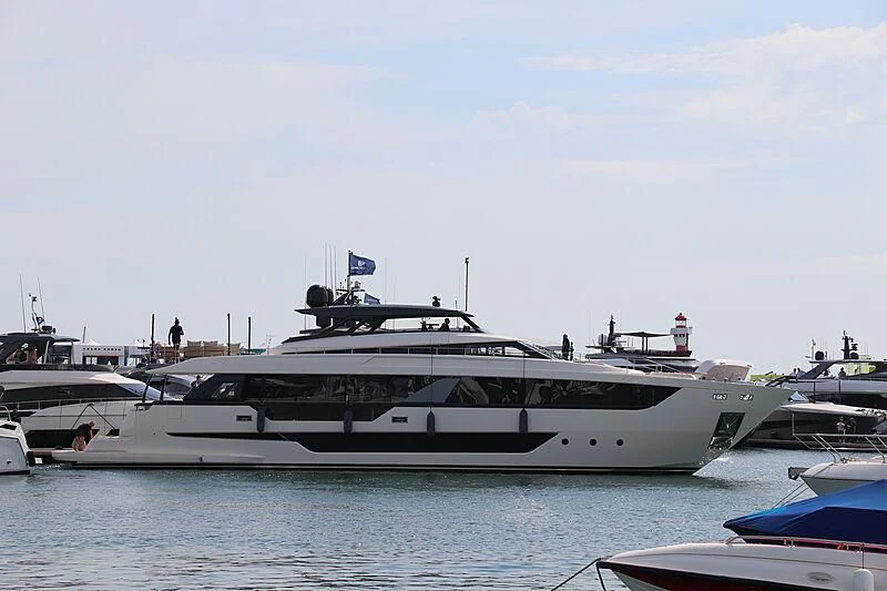 a large white yacht in a harbor aboard EPIC Yacht for Sale