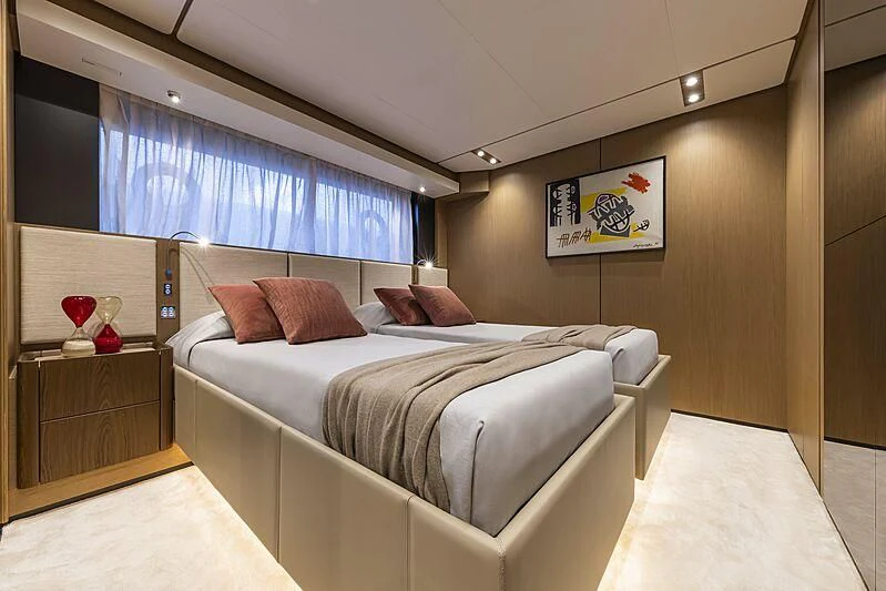 a bedroom with a bed and a window aboard EPIC Yacht for Sale