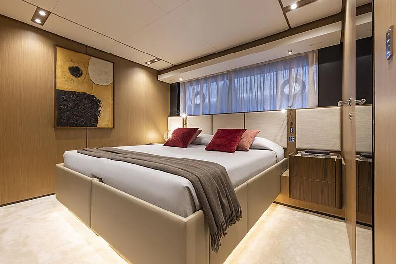 a bedroom with a bed and a desk aboard EPIC Yacht for Sale