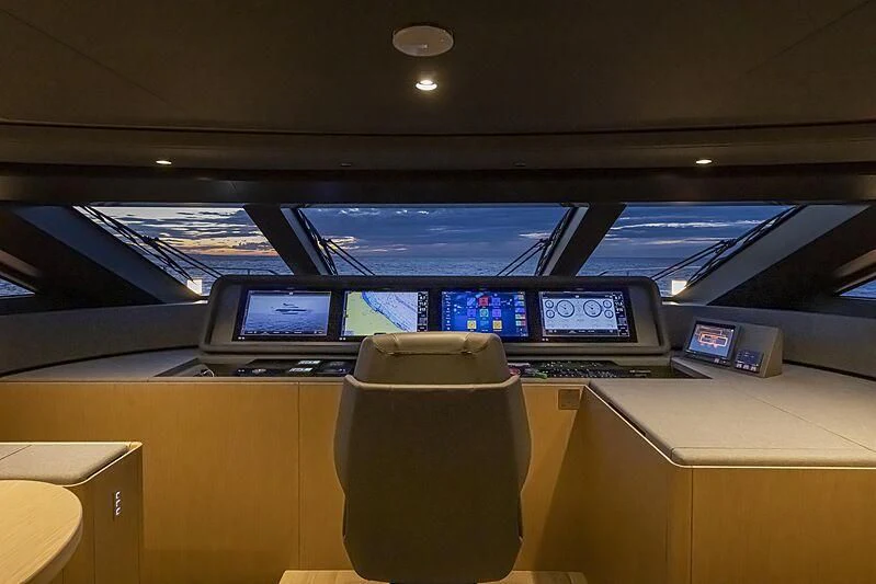 a desk with a laptop and a monitor on it aboard EPIC Yacht for Sale