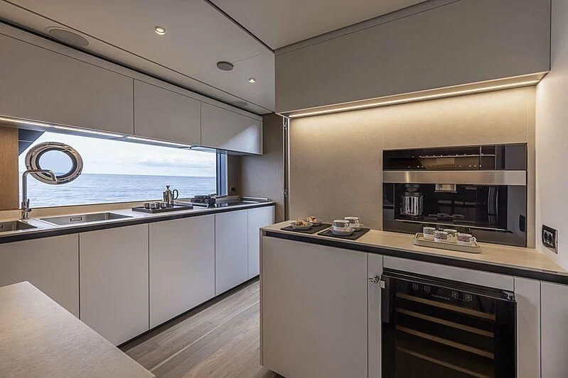 a kitchen with white cabinets aboard EPIC Yacht for Sale
