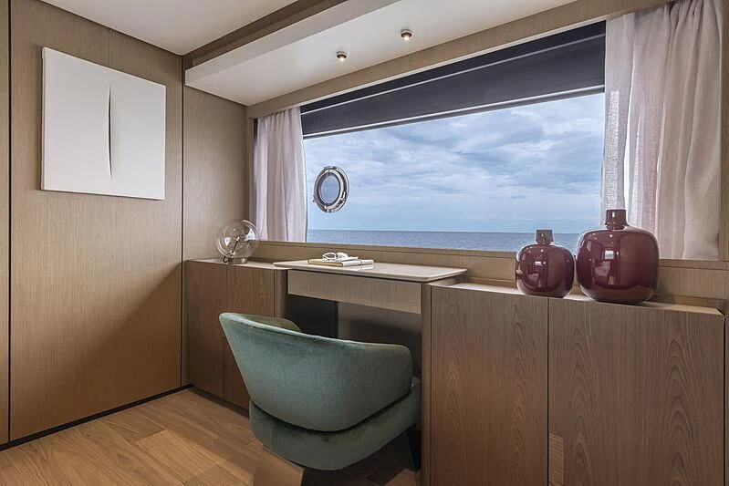 a room with a table and a window aboard EPIC Yacht for Sale
