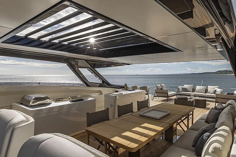 a room with a table and chairs aboard EPIC Yacht for Sale