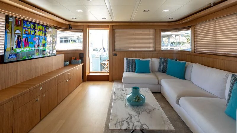 a living room with a couch and a television aboard MARIDAKI Yacht for Sale