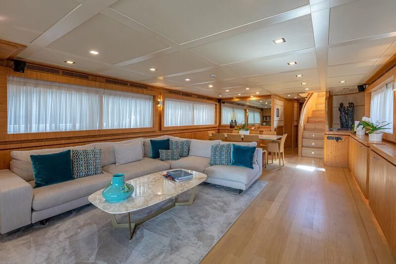 a living room with a couch and a table aboard MARIDAKI Yacht for Sale