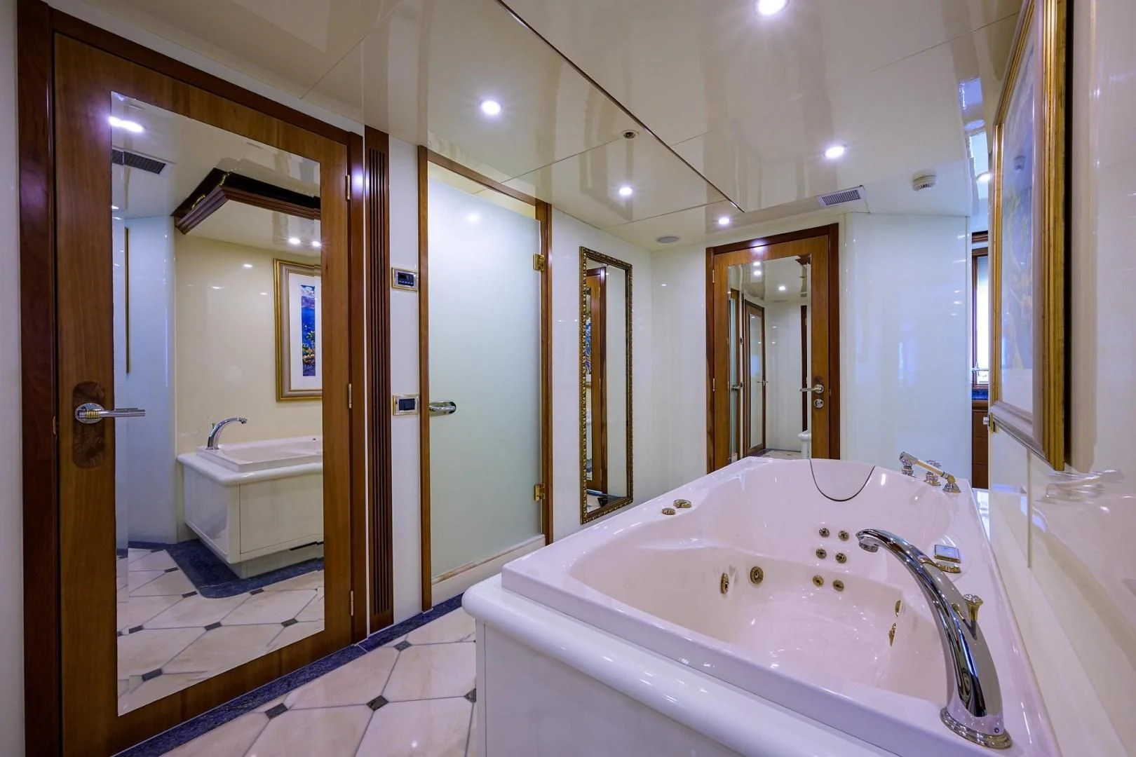 a bathroom with a bathtub and sinks aboard CABERNET Yacht for Sale