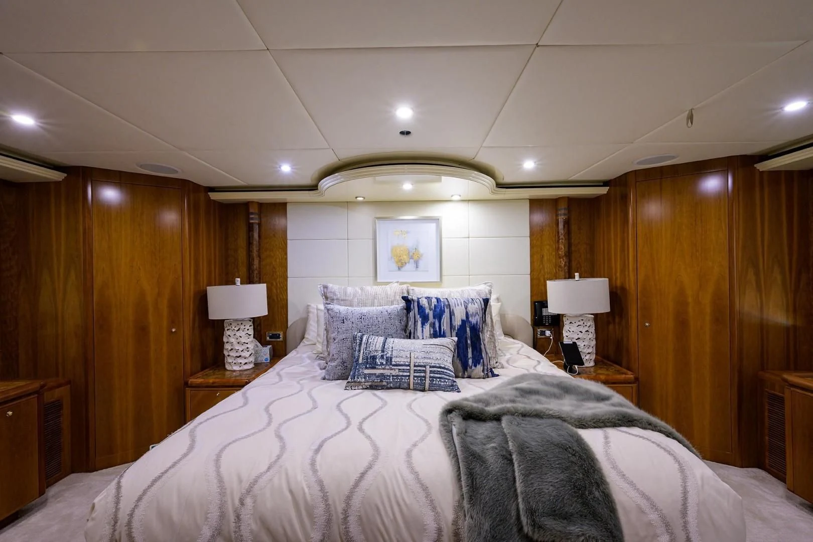 a bedroom with a bed and a lamp aboard CABERNET Yacht for Sale