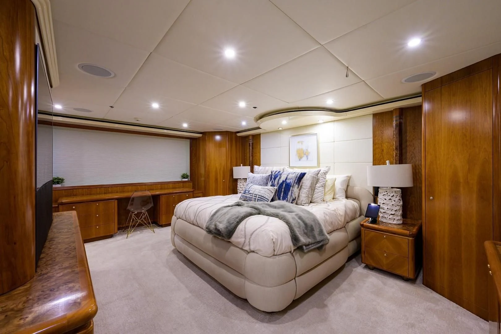 a bedroom with a bed and a desk aboard CABERNET Yacht for Sale